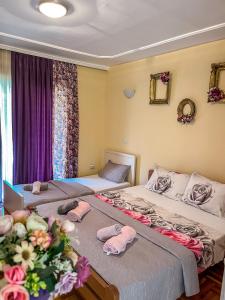 two beds in a room with towels on them at Villa Kraljevski in Kumanovo