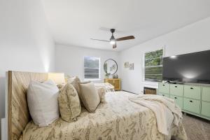 a bedroom with a bed and a flat screen tv at Sunrise - 1322 Indian Point Road in Branson