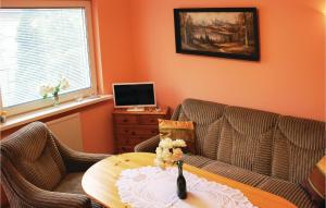 a living room with a couch and a table at Holiday Home Rewal Olszynowa in Rewal +7 photos