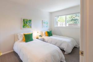 two white beds in a room with a window at Val D Sol Retreat at Perfect Sun Valley Base in Sun Valley +22 photos