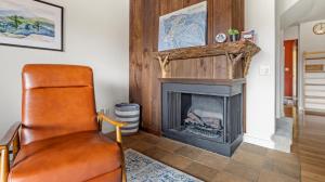 a leather chair in a living room with a fireplace at Bolton Condo condo in Bolton