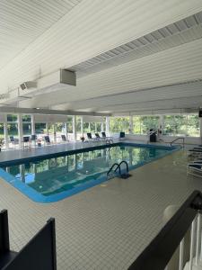 a large swimming pool in a large building at Iris Hotel Cape Cod in Falmouth