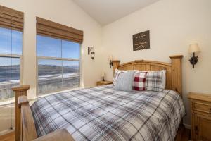 a bedroom with a bed and a large window at Peak View Drive townhouse in Granby +26 photos