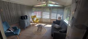 a living room with a couch and chairs and a table at Gîte La Pequelette in Saint-Ambroix