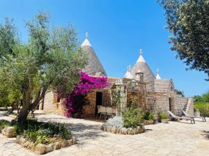 a house with a building with turrets at TRULLO FERNANDO in San Michele Salentino