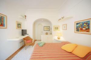 a bedroom with a large bed and a desk at La Piccola, Capri in Capri