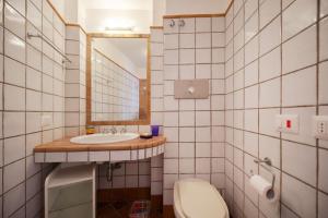 a bathroom with a sink and a toilet and a mirror at La Piccola, Capri in Capri