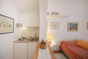 a small bedroom with a bed and a sink at La Piccola, Capri in Capri +18 photos
