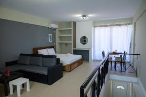 a living room with a bed and a couch at Ι&K studio in Artemida