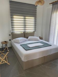 a bedroom with a large bed with a window at Andromachi's House in Pefkochori