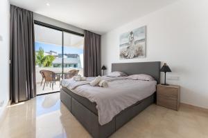 a bedroom with a large bed and a large window at La Valvega de La Cala lift indoor in Mijas +23 photos