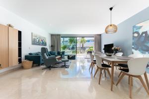 a dining room and living room with a table and chairs at La Valvega de La Cala lift indoor in Mijas