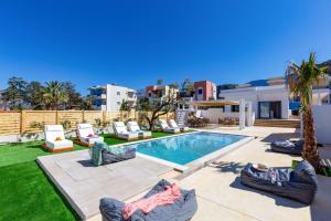 a villa with a swimming pool in a yard at Villa Envy by Villa Plus in Malia