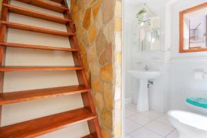 a bathroom with a wooden shelf in a bathroom at Naos Casa Vacanze in Iglesias +40 photos