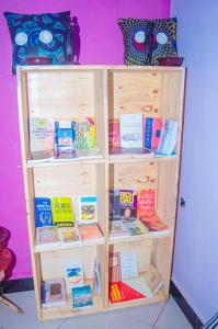 a book shelf filled with lots of books at Tarangwe Homestay & Hostels in Iringa