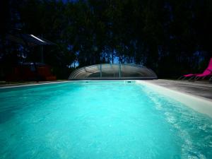 a pool of blue water with a building in the background at Ignaszówka in Radawa +12 photos