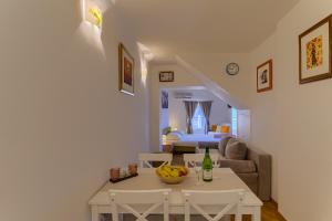 a living room with a table and a couch at Guest House City Center in Korčula