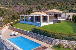 an aerial view of a house with a swimming pool at Villa Drimonas Erato by Villa Plus in Drymon