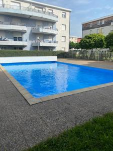 a blue swimming pool in front of a building at l'arc logement in Strasbourg