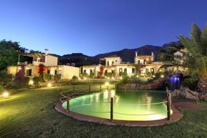 a small pool in the middle of a yard with houses at Politia Villas in Karistos