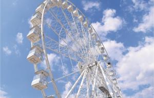 a large white ferris wheel against a cloudy sky at Villino Anna in Viareggio