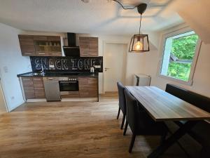 a kitchen with a wooden table and a dining room at Time-Out in Monschau
