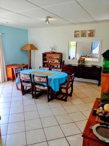 a dining room with a table and chairs and a room at Peace Cottage in St Lucia