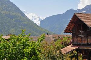 a view of a village with mountains in the background at Jungfrau Views Apartment in Interlaken