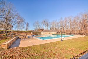 a swimming pool in a yard with a house at Lakefront Crossville Condo - Fish, Boat and Golf! in Fairfield Glade