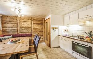 a kitchen with a wooden table and a counter at Ferienhaus - Kloesterle in Wilden