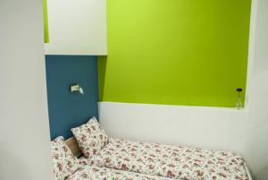 ブダペストにあるBlue home in the heart of Budapestの緑の壁の客室で、ソファが備わります。