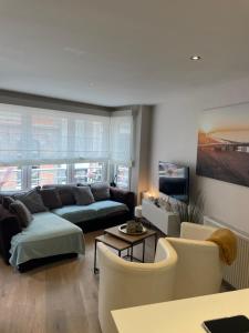 a living room with a couch and chairs at ERNA in Blankenberge