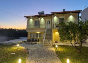 a house with a staircase leading up to it at Loridis Central Apartments in Prinos