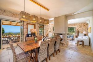 a dining room and living room with a table and chairs at Villa Hlazeika by Villa Plus in Old Skala