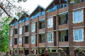 a large red brick building with many windows at old house ureki in Ureki