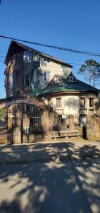 a large brick building with a balcony on a street at old house ureki in Ureki