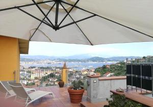 a balcony with chairs and a view of a city at I POGGI SUL GOLFO in La Spezia