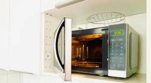 a microwave oven with its door open in a kitchen at City flat 8 in Ingolstadt