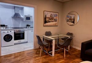 a kitchen and dining room with a table and chairs at VUT PLAZA DEL ANGEL in Salamanca +35 photos