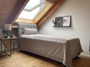 a bedroom with a bed and a table and a window at Fewo-Forum in Kempten