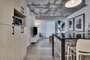 a kitchen and dining room with a table and chairs at Condo - 305 Piscine BBQ WIFI in Quebec City
