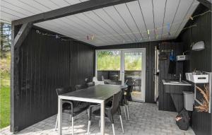 a dining room with a table and chairs at Holiday Home Næsehornsvej Ålbæk X in Ålbæk +23 photos
