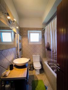 a bathroom with a sink and a toilet and a tub at Bella Vista in Dhíkella +18 photos