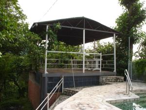 a pavilion with a pool in a garden at Sarpi in Sarpi