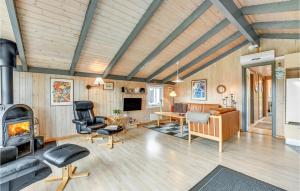 a living room with wood paneling and a fireplace at Amazing Home In Hvide Sande With Wifi in Bjerregård