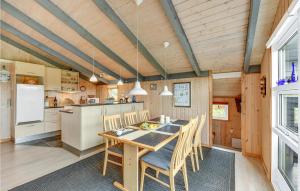 a kitchen and dining room with a table and chairs at Amazing Home In Hvide Sande With Wifi in Bjerregård