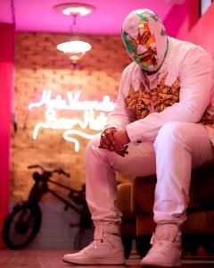 a man sitting on a chair with a helmet at Mala Vecindad Centro Historico in Mexico City