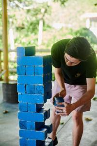 a man standing next to a stack of blue bricks at Fundo San Jose Parque Ecológico & Lodge Hotel Asociado Casa Andina in La Merced