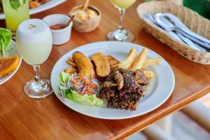 a plate of food with a sandwich and french fries at Fundo San Jose Parque Ecológico & Lodge Hotel Asociado Casa Andina in La Merced