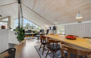 a kitchen and dining room with a table and chairs at Holiday Home Mosebøllevej Thisted Denm in Nørre Vorupør